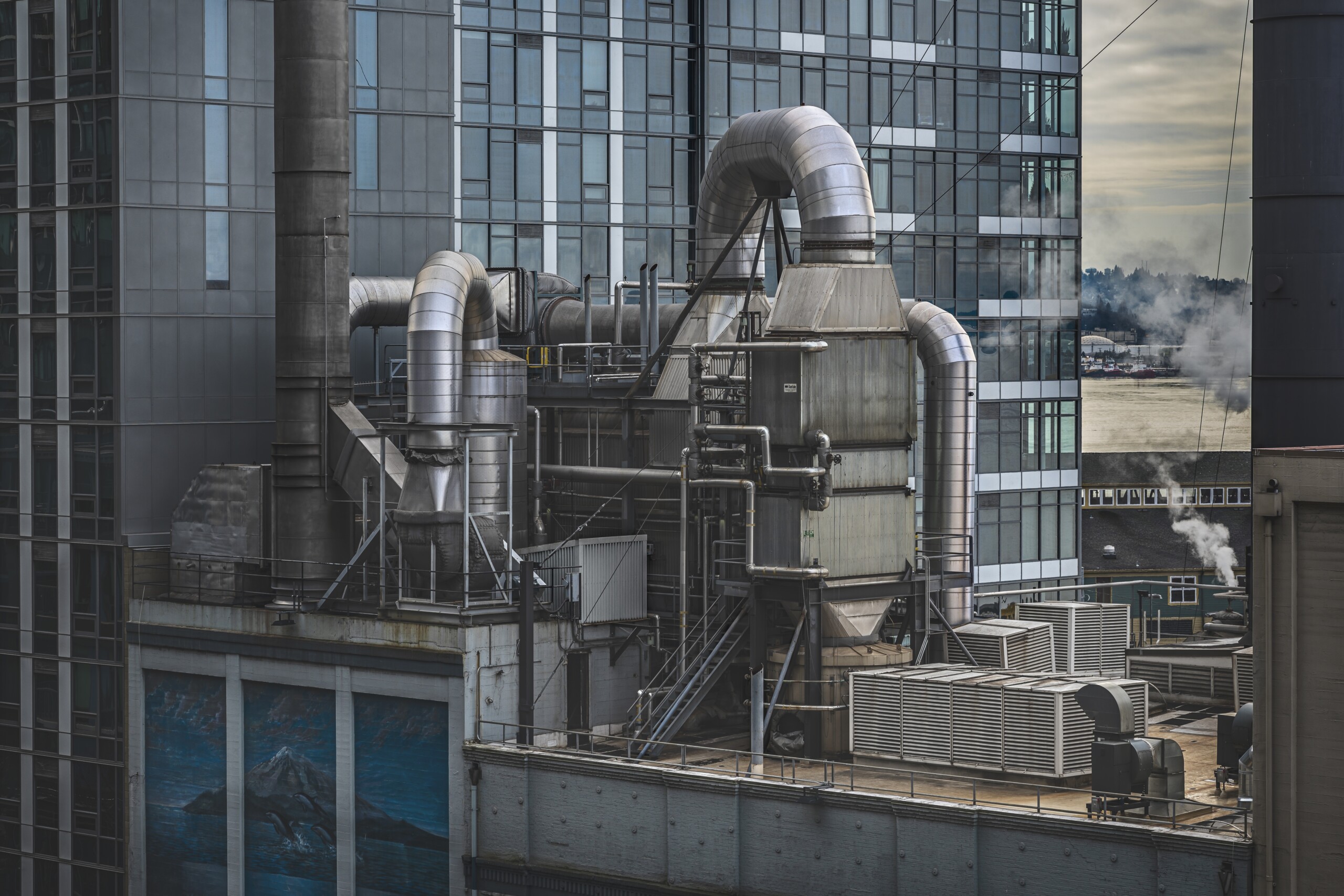 Factory surrounded by high-rise buildings with greenery on the background in Seattle